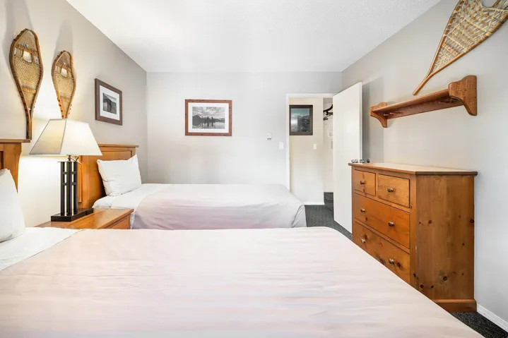 Bedroom with dark carpet and baseboards