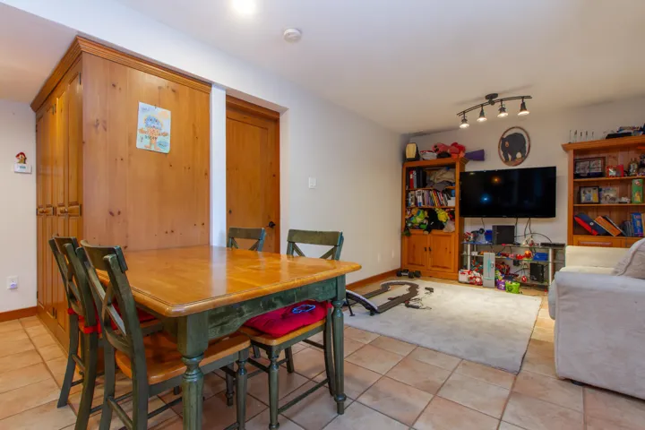 Dining space featuring light tile patterned floors and baseboards
