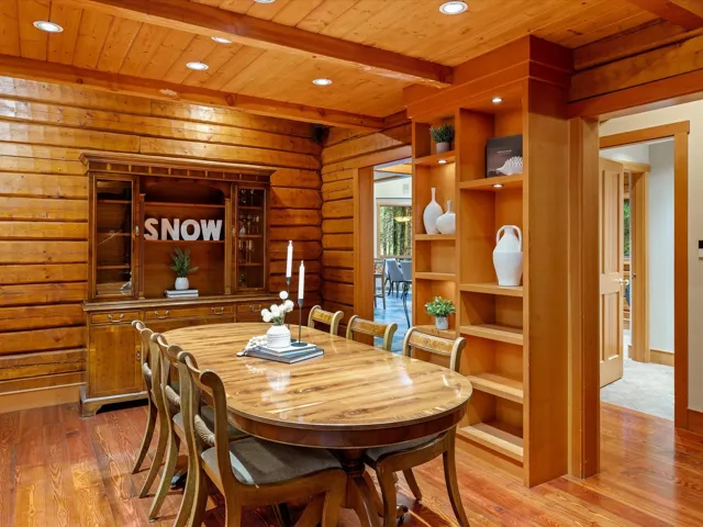 Dining area with log walls, light wood-type flooring, recessed lighting, and a wood ceiling with exposed beams