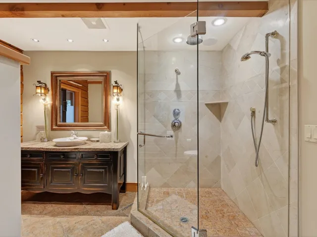 Full bath featuring vanity, a stall shower, and recessed lighting