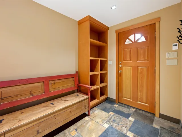Entrance foyer featuring stone tile flooring and baseboards
