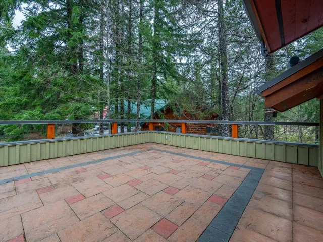 View of patio / terrace with view of wooded area