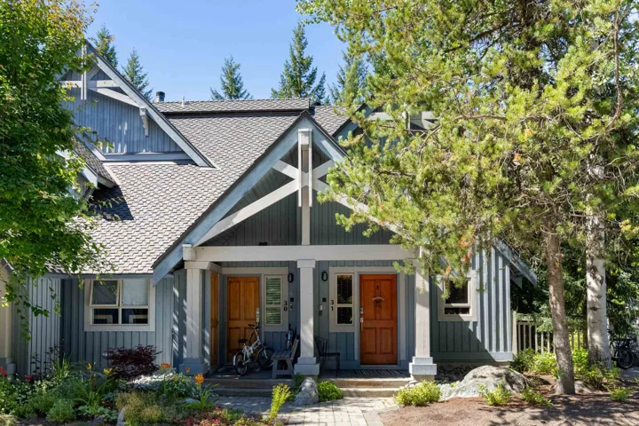 View of front of house with a porch, a shingled roof, and board and batten siding