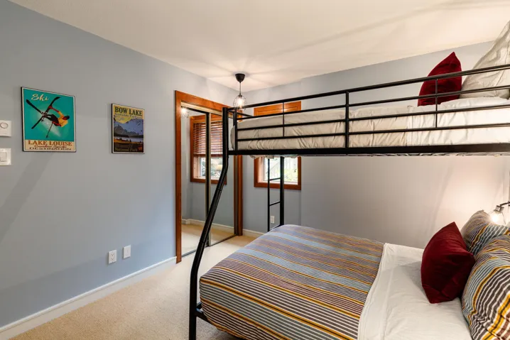 Bedroom with light colored carpet and a closet