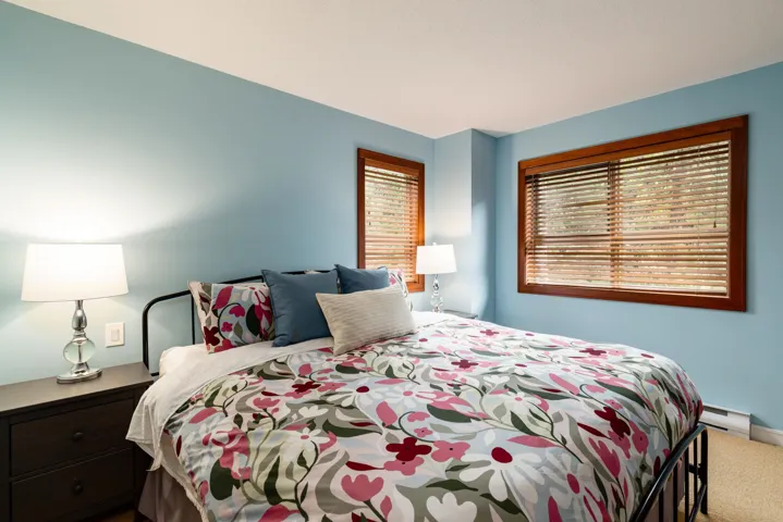 Carpeted bedroom with baseboard heating