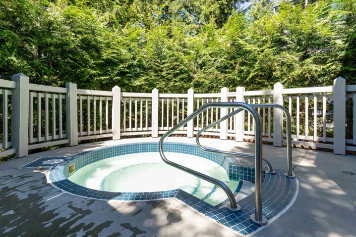 View of swimming pool with an in-ground hot tub and a patio area