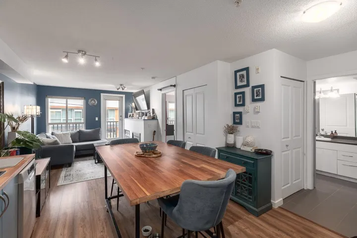 Dining area featuring dark wood-type flooring and a textured ceiling