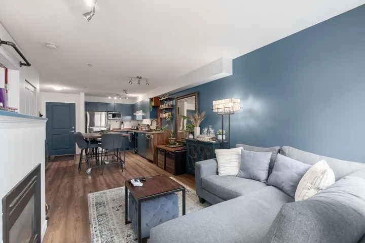 Living area featuring track lighting and dark wood finished floors