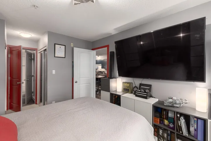 Bedroom featuring a textured ceiling and a closet