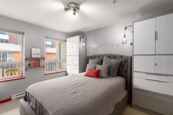 Bedroom featuring ensuite bath, a closet, and a textured ceiling