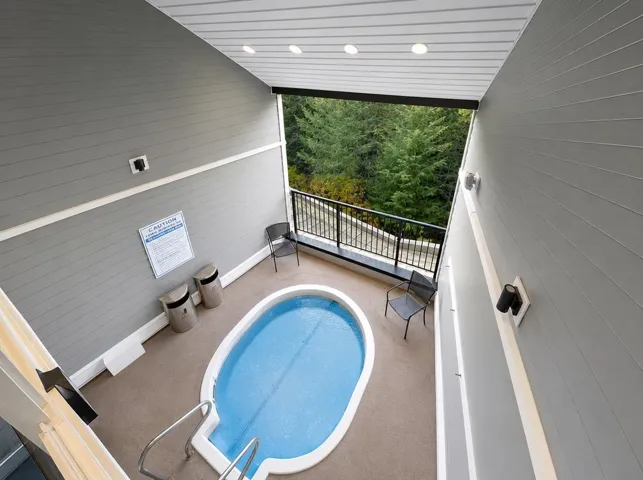Outdoor spa tub with integrated steps and stainless steel handrails