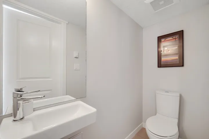 Half bath featuring a textured ceiling and light tile patterned floors