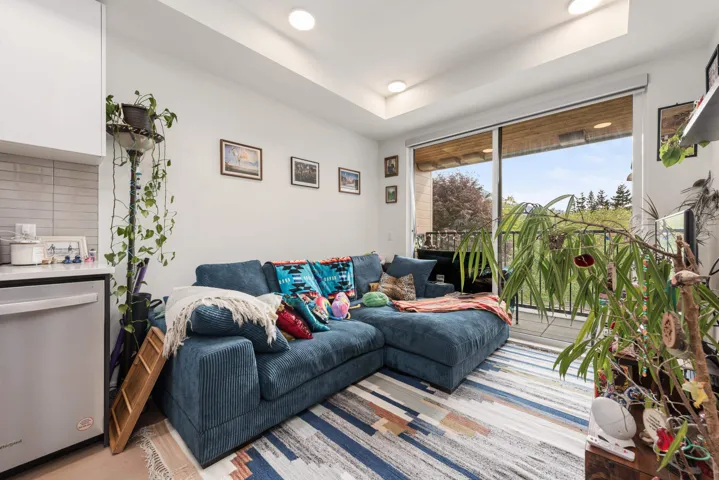 Living area with recessed lighting and direct access to an outdoor balcony