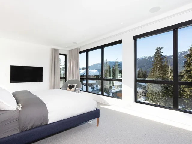 Carpeted bedroom with a mountain view
