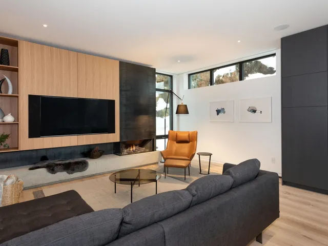 Living area featuring a fireplace, light wood finished floors, and floor to ceiling windows