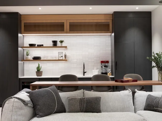 Bar area with dark cabinetry, light countertops, open shelves, backsplash, and recessed lighting
