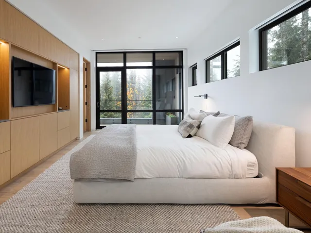 Bedroom featuring a wall of windows, light wood-type flooring, and recessed lighting