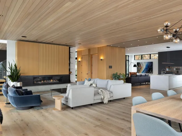 Living area featuring wooden ceiling, light wood-type flooring, a glass covered fireplace, and a chandelier