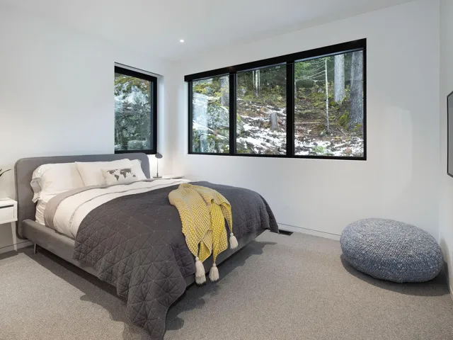 Bedroom featuring carpet flooring and baseboards