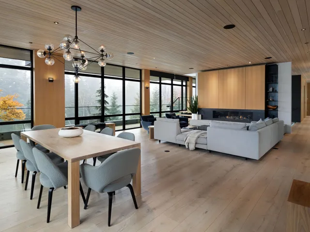 Dining space featuring wood ceiling, expansive windows, light wood-style flooring, and a chandelier