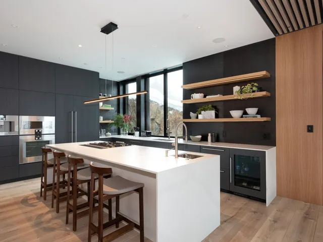 Bar with open shelves, modern cabinets, expansive windows, light wood-style flooring, and dark cabinetry