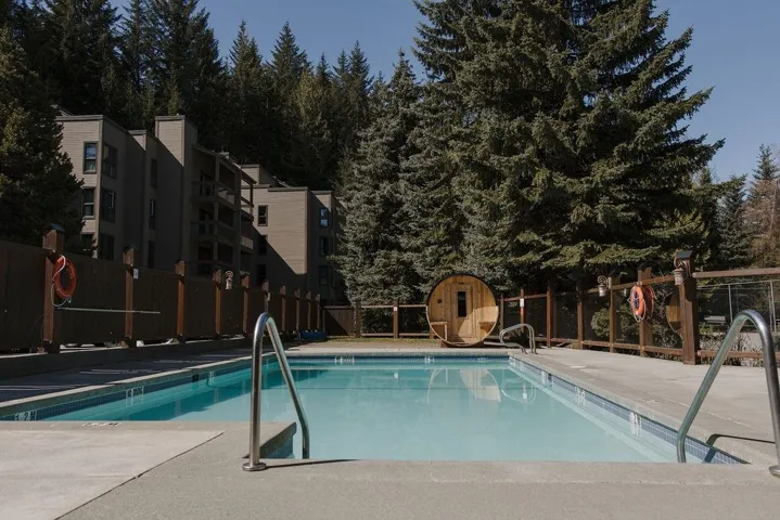 Community pool with a patio