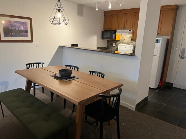Dining room with rail lighting and dark carpet