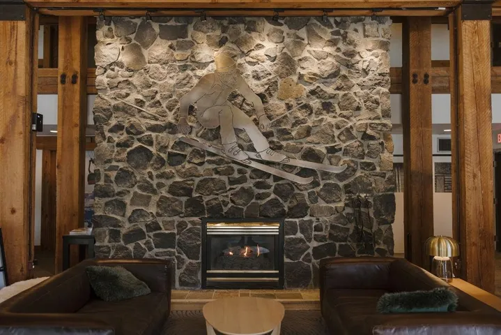 Unfurnished living room with a stone fireplace