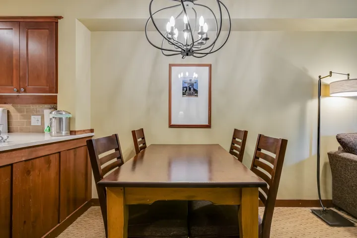 Dining area featuring a chandelier and baseboards