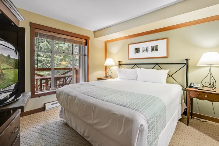 Carpeted bedroom with a baseboard radiator and baseboards