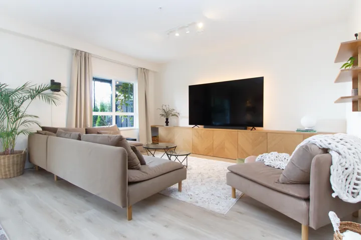 Living area featuring light wood-style flooring and track lighting
