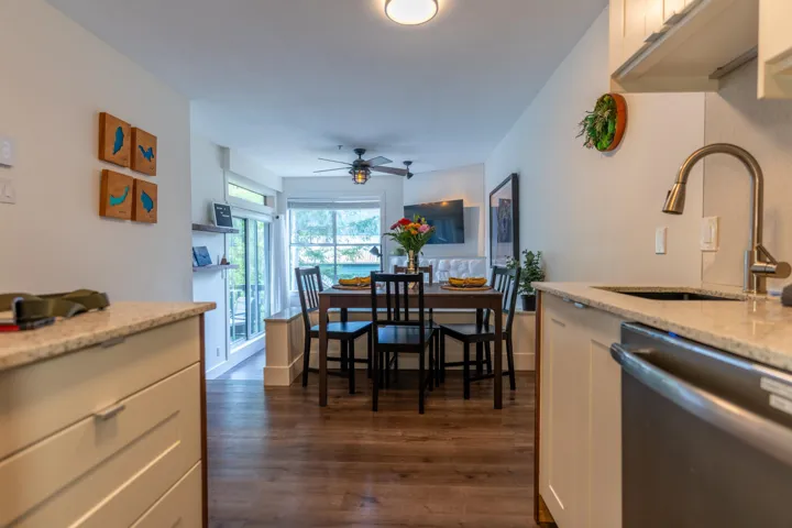 Dining room with a ceiling fan and dark wood-type flooring