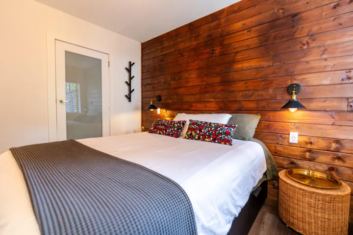 Bedroom with wooden walls and ensuite bathroom