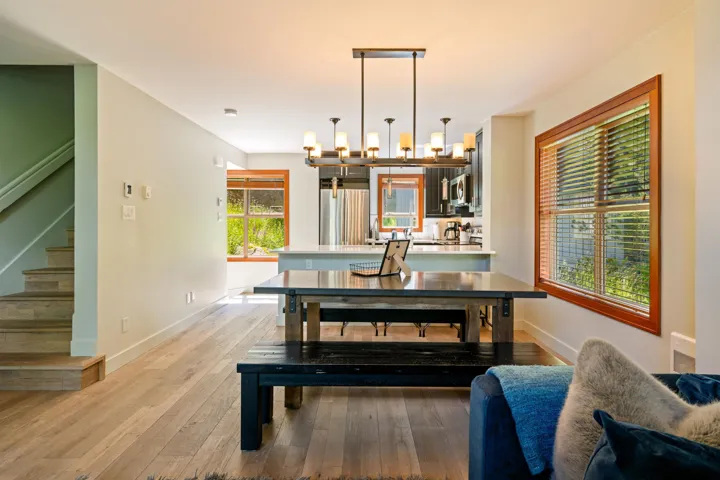 Dining area featuring a chandelier, stairs, and light wood-style floors