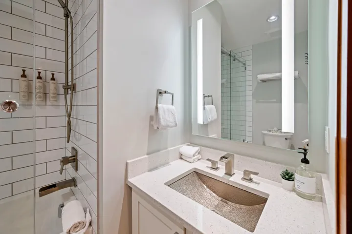 Full bath with a tile shower and vanity