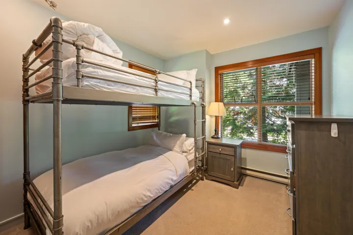 Bedroom featuring light carpet, a baseboard heating unit, and recessed lighting