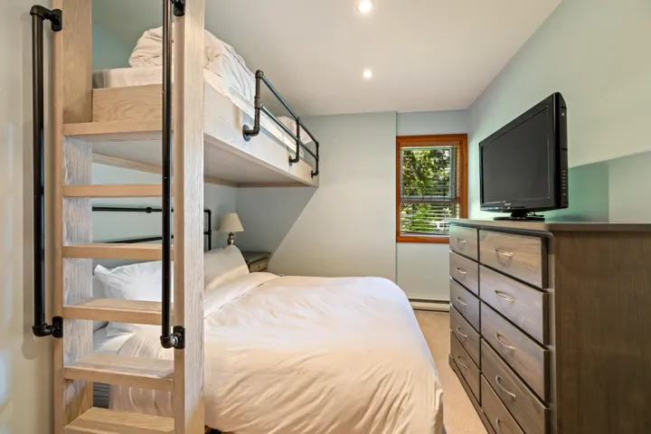 Bedroom featuring light colored carpet, recessed lighting, and a baseboard radiator