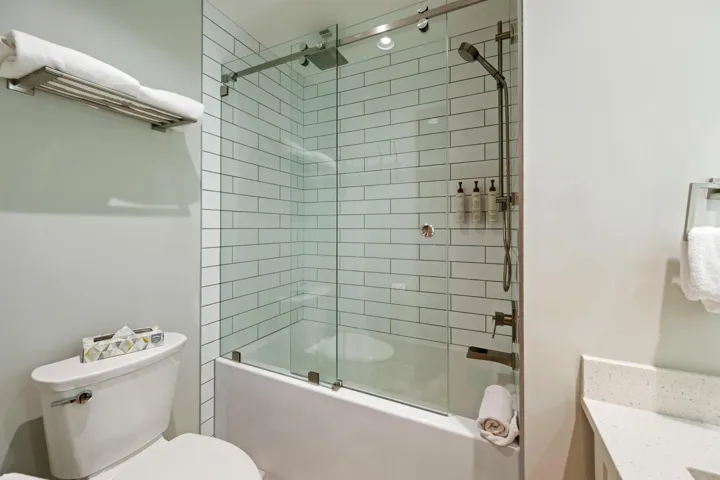 Full bath featuring enclosed tub / shower combo and vanity