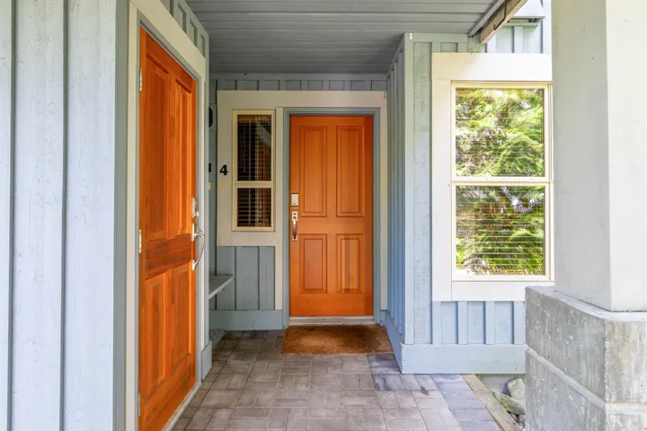 Property entrance featuring board and batten siding
