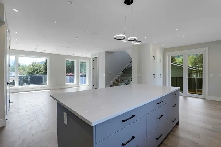 Kitchen with a center island, gray cabinets, pendant lighting, light wood finished floors, and recessed lighting