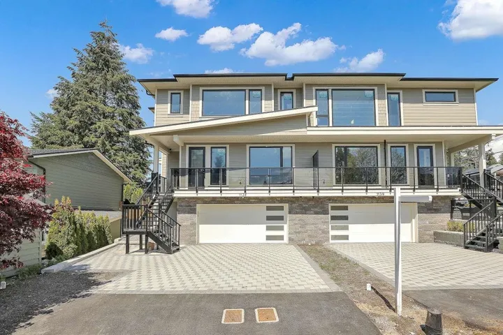View of front of property with stairs, a garage, decorative driveway, and a balcony