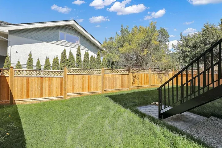 Fenced backyard with stairs