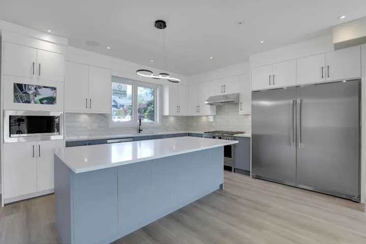 Kitchen featuring built in appliances, white cabinets, decorative light fixtures, gray cabinets, and recessed lighting