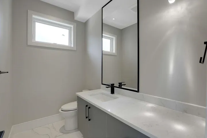 Bathroom featuring vanity and light marble finish flooring