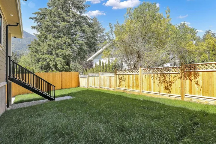 Fenced backyard featuring stairs