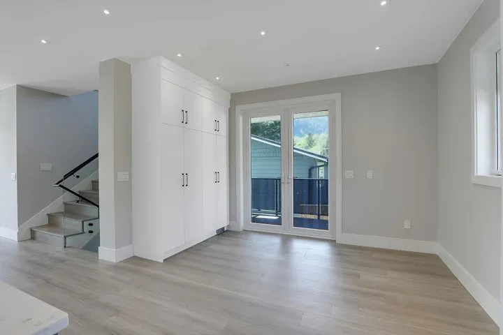 Unfurnished room featuring recessed lighting, light wood-style flooring, and stairs