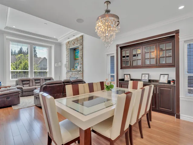 Dining area with wood-finish flooring and a crystal chandelier