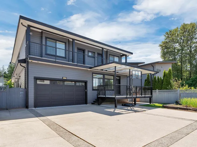 Modern two-story residence featuring gray siding and black trim