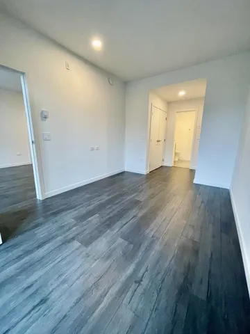 Unfurnished room with dark wood finished floors and recessed lighting