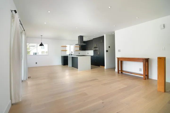 Unfurnished living room with baseboards, light wood finished floors, and recessed lighting